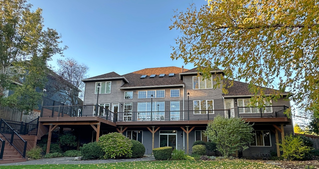 Large two-story home with a new upper deck on timber posts