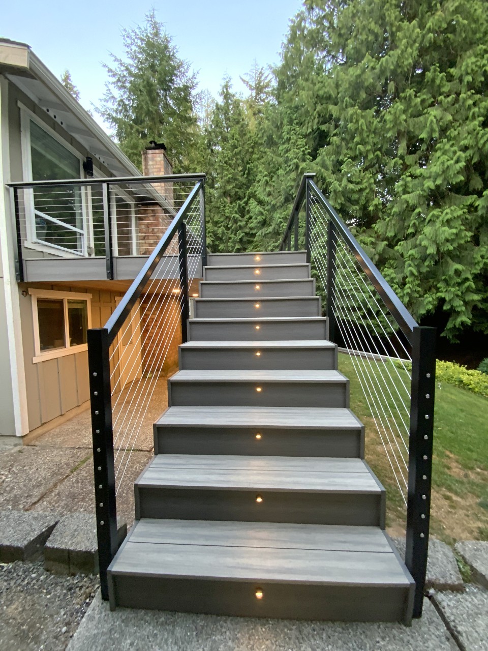 Composite stairs with cable railing and lit risers