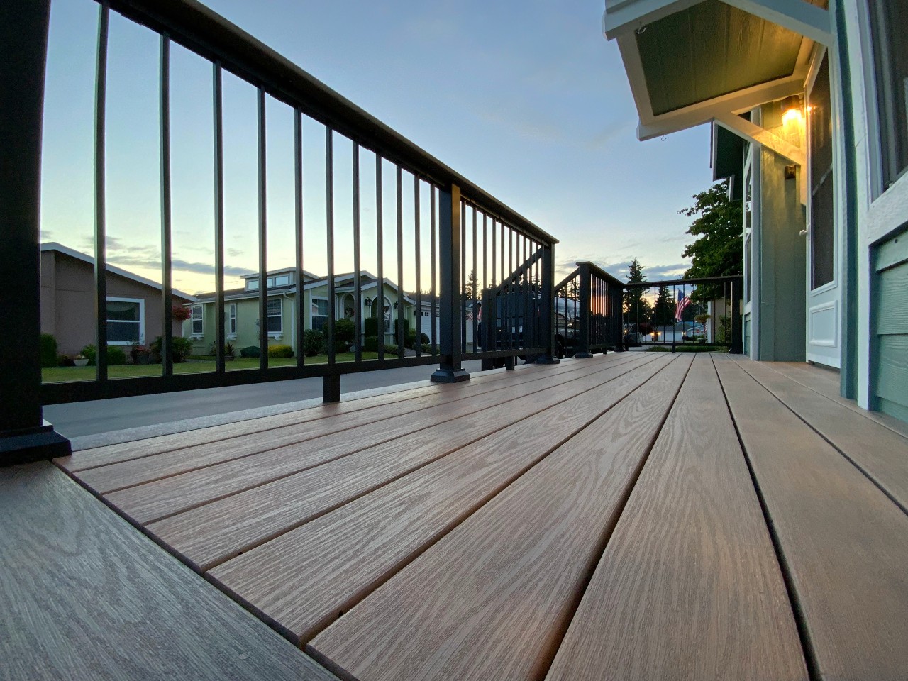 Composite deck with black aluminum railing at sunset