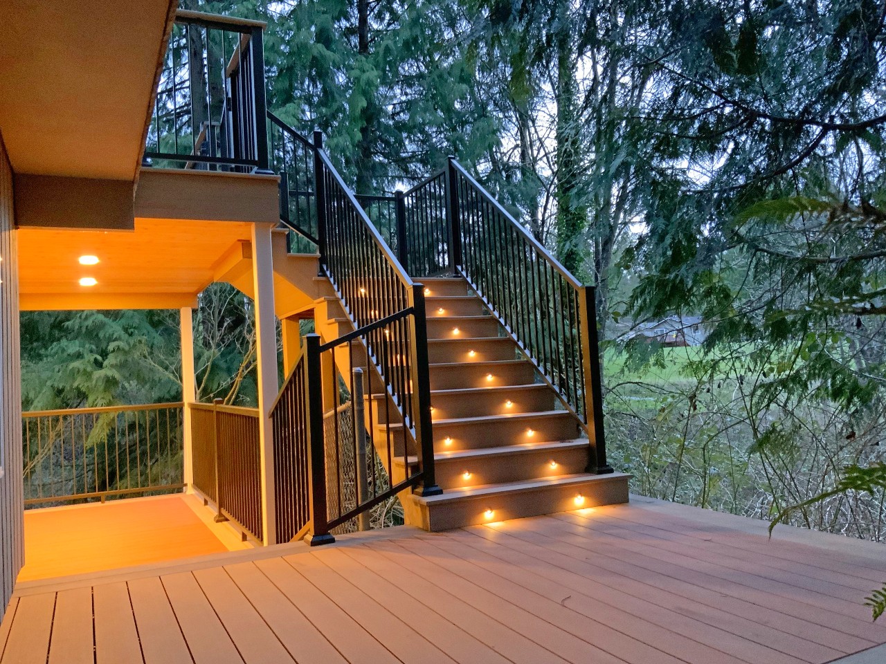 Composite deck stairs with riser lighting at dusk