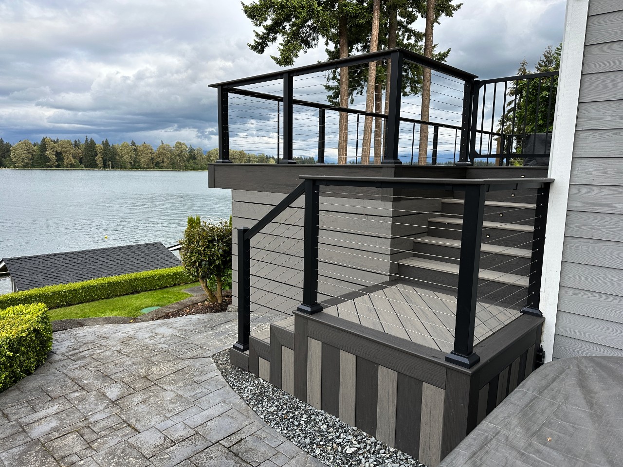 Lakefront composite deck with cable railing and built-in stairs
