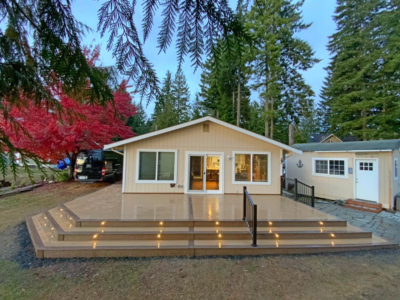 Low composite platform deck with step lighting on a tan rambler