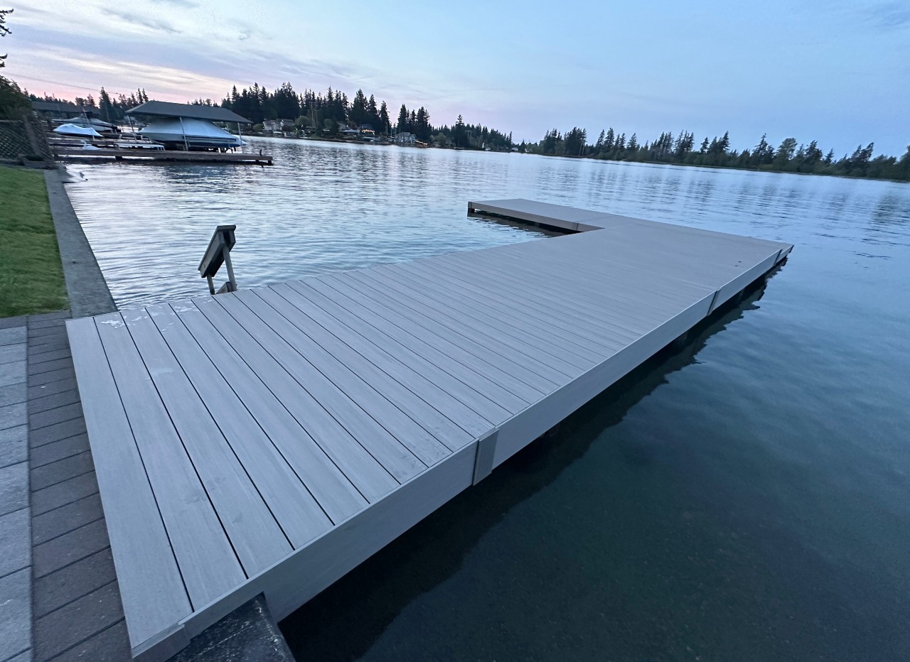 Grey composite dock extending into the lake