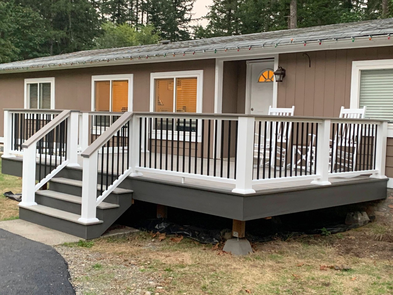 Composite deck with white railing and dark skirting on a rambler