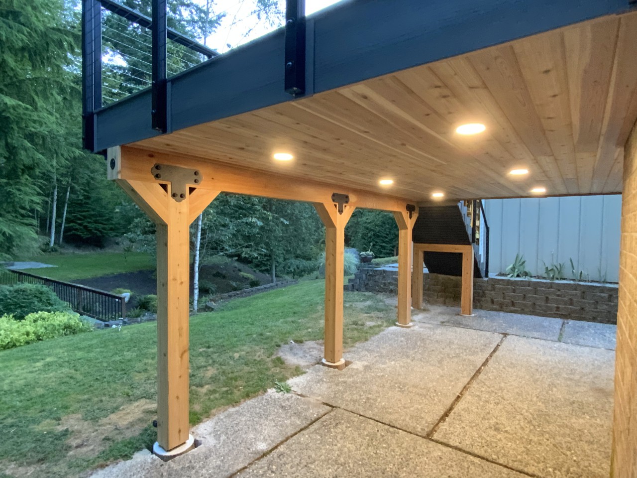 Covered patio with timber posts and a tongue-and-groove wood ceiling