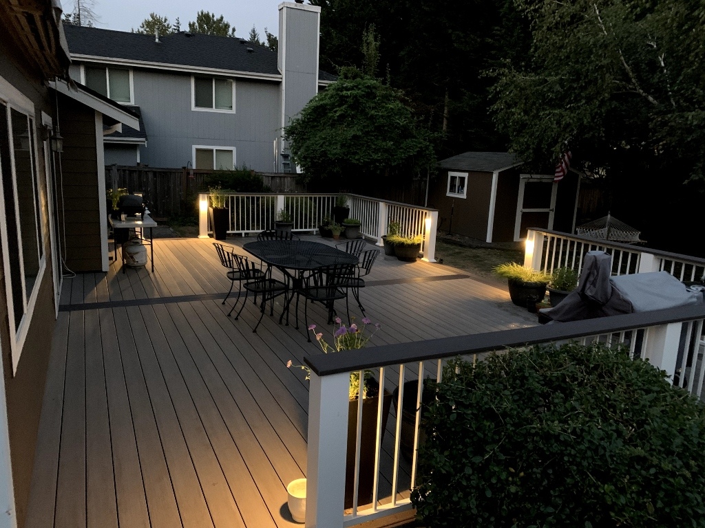 Composite deck with post lights and outdoor dining at night
